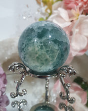 Load image into Gallery viewer, Fluorite Sphere Crystal Carving Stone on Silver Stand
Inspires CONCENTRATION AND STABILITY
Lovely Fluorite Crystal Sphere on silver stand. super pretty. Feather fluorite. Amazing pattern.