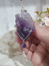 Load image into Gallery viewer, "THE MYSTIC AWAKENING" Handcrafted Amethyst Raw Crystal Stone Silver Crystal Energy Enhancer© Hanger Ornament Suncatcher
INSPIRES INTUITION, WISDOM AND SPIRITUALITY
Stunning Raw Amethyst crystal stone beaded with Amethyst and Quartz. Wire wrapped in silver
Genuine Crystals. no plastic or glass. Ensuring energy flow throughout the enhancer. Hang in your home, work, space and even on your Christmas tree!.
Genuine Crystal Suncatchers Hangers Christmas Tree Ornaments decorations