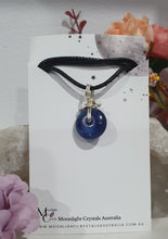 Load image into Gallery viewer, Stunning Blue Kyanite crystal stone donut crystal carving wire wrapped in non tarnish silver wire. Come with a black cork necklace.