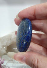 Load image into Gallery viewer, Lapis Lazuli Crystal Palm Stone palm stone on plastic stand.
INSPIRES HARMONY, WISDOM & PSYCHIC PROTECTION
Lovely Lapis Lazuli Crystal Palm stone with pyrite inclusions on plastic stand. So pretty.