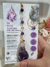 Load image into Gallery viewer, THE MYSTIC AWAKENING" Handcrafted Amethyst Raw Crystal Stone Gold Crystal Energy Enhancer© Hanger Ornament Suncatcher
INSPIRES INTUITION, WISDOM AND SPIRITUALITY
Stunning Raw Amethyst crystal stone beaded with Amethyst and Quartz. Wire wrapped in gold.