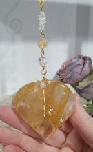 Load image into Gallery viewer, This stunning Ultimate Healer Crystal Energy Enhancer Suncatcher is handcrafted and created with a stunning Golden Healer heart and beaded with golden healer and quartz. Hang in your home or space and feel the ambient energy. Inspires Power and connection. See our other Crystal Suncatchers