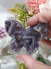 Load image into Gallery viewer, Butterfly Amethyst Crystal Carving Stone on Stand. Inspires Intuition and Spirituality.
Beautiful polished Amethyst Chevron Butterfly Crystal Carving on plastic stand