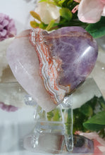 Load image into Gallery viewer, Amethyst Agate Heart Crystal Carving Stone on plastic Stand
Inspires intuition and Emotional Well Being
Beautiful Polished Amethyst Agate Heart Crystal Carving on plastic stand. Has natural formations.