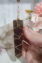 Load image into Gallery viewer, WAND OF STRENGTH" Handcrafted Smoky Quartz Tower Point Stone Gold Crystal Energy Enhancer© Hanger Ornament Suncatcher
Inspires GROUNDING | LOVE | STABILITY
Gorgeous Smoky Quartz crystal tower beaded with Smoky Quartz, Rose Quartz and Herkimer Diamond. Wire wrapped in gold