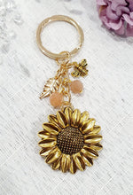 Load image into Gallery viewer, THE SUNFLOWER KEEPER" Metal Sunflower with Sunstone Beads Crystal Keyring.
Choose from Gold of Silver medal colour.
INSPIRES JOY | HOPE | OPTIMISM
Carry a little Sunshine wherever life takes you!
"The sunflower has long symbolised joy, hope and unwavering optimism. Like the flower that turns towards the sun, it reminds us to keep looking for the light, even through life's difficult seasons".
Gorgeous Metal sunflower Keyring Key ring beaded with AAA sunstone faceted beads.