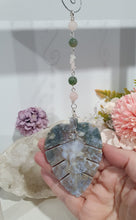 Load image into Gallery viewer, LEAF OF RENEWAL - Handcrafted Moss Agate Leaf silver Crystal Energy Enhancer© / Hanger / Ornament / Suncatcher
SPIRITUAL GROWTH | LOVE | BALANCE
Gorgeous Moss Agate leaf crystal carving beaded with Rose Quartz & Moss Agate. Wire wrapped in silver
Genuine Crystals. no plastic or glass. Ensuring energy flow throughout the enhancer.