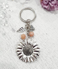 Load image into Gallery viewer, THE SUNFLOWER KEEPER" Metal Sunflower with Sunstone Beads Crystal Keyring.
Choose from Gold of Silver medal colour.
INSPIRES JOY | HOPE | OPTIMISM
Carry a little Sunshine wherever life takes you!
"The sunflower has long symbolised joy, hope and unwavering optimism. Like the flower that turns towards the sun, it reminds us to keep looking for the light, even through life's difficult seasons".
Gorgeous Metal sunflower Keyring Key ring beaded with AAA sunstone faceted beads.