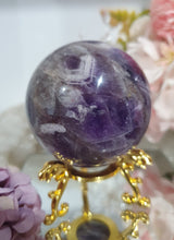 Load image into Gallery viewer, Amethyst Chevron Sphere Crystal Carving Stone on Gold Stand
Inspires INTUITION AND SPIRITUALITY
Lovely Amethyst Crystal Sphere on gold stand. Gorgeous colouring.