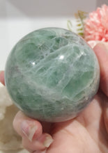 Load image into Gallery viewer, Beautiful Fluorite Sphere Crystal Carving on Silver Stand. Inspires Stability, Grounding and Concentration. Lovely patterns and colouring with inclusions.