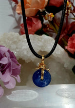 Load image into Gallery viewer, Stunning Blue Kyanite crystal stone donut crystal carving wire wrapped in non tarnish gold wire. Come with a black cork necklace.