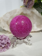 Load image into Gallery viewer, Ruby Sphere Crystal Carving on Silver Stand. Inspires Attraction and Sensuality. Sphere is a little darker than pics show