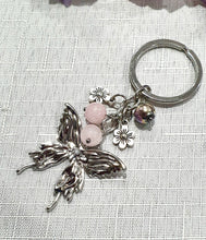 Load image into Gallery viewer, THE BUTTERFLY MESSENGER " Metal Butterfly Keyring Key chain with Rose Quartz & Rainbow Hematite Beads Stone Silver Crystal Key Ring
INSPIRES CONNECTION, LOVE & TRANSFORMATION
Carry a little Love wherever life takes you.
Lovely silver coloured metal Butterfly Keyring Key ring keychain with flower charms, beaded with Rose Quartz and Rainbow Hematite.