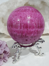 Load image into Gallery viewer, Ruby Sphere Crystal Carving on Silver Stand. Inspires Attraction and Sensuality. Sphere is a little darker than pics show