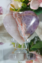Load image into Gallery viewer, Amethyst Agate Heart Crystal Carving Stone on plastic Stand

Inspires intuition and Emotional Well Being

Beautiful Polished Amethyst Agate Heart Crystal Carving on plastic stand. Has natural formations.
