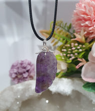 Load image into Gallery viewer, "WING OF AN ANGEL" Amethyst Angel Wing Crystal Stone Pendant wire wrapped Silver .

Inspires Divine Connection and Intuition.

Angel Wings symbolise love, protection, purity and freedom. Connections to the Angels and divine realm.

Beautiful handcrafted Amethyst Angel Wing Crystal Carving Pendant in silver non tarnish wire. Comes with a cord necklace.
