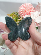 Load image into Gallery viewer, Butterfly Moss Agate Crystal Carving Stone on Stand. Inspires tranquility and grounding.

Beautiful polished Moss Agate Butterfly Crystal Carving on plastic stand
