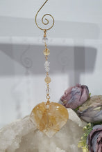 Load image into Gallery viewer, This stunning Ultimate Healer Crystal Energy Enhancer Suncatcher is handcrafted and created with a stunning Golden Healer heart and beaded with golden healer and quartz. Hang in your home or space and feel the ambient energy. Inspires Power and connection. See our other Crystal Suncatchers
