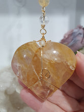 Load image into Gallery viewer, This stunning Ultimate Healer Crystal Energy Enhancer Suncatcher is handcrafted and created with a stunning Golden Healer heart and beaded with golden healer and quartz. Hang in your home or space and feel the ambient energy. Inspires Power and connection. See our other Crystal Suncatchers
