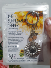 Load image into Gallery viewer, "THE SUNFLOWER KEEPER" Metal Sunflower with Sunstone Beads Crystal Keyring.

&nbsp;"The sunflower has long symbolised joy, hope and unwavering optimism. Like the flower that turns towards the sun, it reminds us to keep looking for the light, even through life's difficult seasons".

Gorgeous Metal sunflower Keyring Key ring beaded with AAA sunstone faceted beads.
