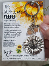 Load image into Gallery viewer, "THE SUNFLOWER KEEPER" Metal Sunflower with Sunstone Beads Crystal Keyring.

&nbsp;"The sunflower has long symbolised joy, hope and unwavering optimism. Like the flower that turns towards the sun, it reminds us to keep looking for the light, even through life's difficult seasons".

Gorgeous Metal sunflower Keyring Key ring beaded with AAA sunstone faceted beads.
