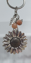 Load image into Gallery viewer, "THE SUNFLOWER KEEPER" Metal Sunflower with Sunstone Beads Crystal Keyring.

&nbsp;"The sunflower has long symbolised joy, hope and unwavering optimism. Like the flower that turns towards the sun, it reminds us to keep looking for the light, even through life's difficult seasons".

Gorgeous Metal sunflower Keyring Key ring beaded with AAA sunstone faceted beads.
