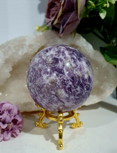 Load image into Gallery viewer, Unicorn Stone Sphere Crystal Carving on Gold Stand. Inspires Calmness, Empathy and Joy. 
Unicorn Stone consists of Pink Tourmaline, Lepidolite &amp; Smokey Quartz

