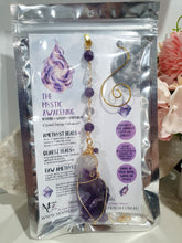 Load image into Gallery viewer, THE MYSTIC AWAKENING" Handcrafted Amethyst Raw Crystal Stone Gold Crystal Energy Enhancer© Hanger Ornament Suncatcher

INSPIRES INTUITION, WISDOM AND SPIRITUALITY

Stunning Raw Amethyst crystal stone beaded with Amethyst and Quartz. Wire wrapped in gold.
