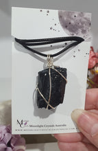 Load image into Gallery viewer, Gorgeous Black Tourmaline crystal stone wire wrapped in silver with black cord. Black Tourmaline promotes protective energy. 
