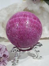 Load image into Gallery viewer, Ruby Sphere Crystal Carving on Silver Stand.  Inspires Attraction and Sensuality. Sphere is a little darker than pics show
