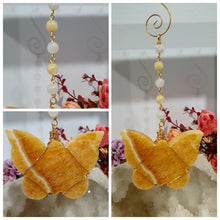 Load image into Gallery viewer, Beautiful polished Butterfly of Joy and manifestation Crystal Energy Enhancer / Sun catcher / Hanger / Ornament. Orange Calcite Butterfly Crystal Carving beaded with golden healer and moonstone.   
