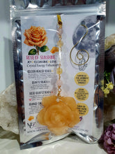 Load image into Gallery viewer, Stunning "ROSE OF SUNSHINE" Handcrafted Orange Calcite Rose Carving gold Crystal Energy Enhancer© Hanger Ornament Suncatcher. hang in your room or space. Inspires Joy, cleansing and love
