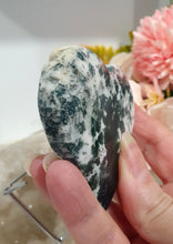Load image into Gallery viewer, Heart Moss Agate Crystal Carving Stone on stand

INSPIRES GROUNDING AND CONNECTION TO EARTH

Lovely Moss Agate Heart Crystal Carving on silver stand. 

