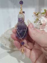 Load image into Gallery viewer, THE MYSTIC AWAKENING" Handcrafted Amethyst Raw Crystal Stone Gold Crystal Energy Enhancer© Hanger Ornament Suncatcher

INSPIRES INTUITION, WISDOM AND SPIRITUALITY

Stunning Raw Amethyst crystal stone beaded with Amethyst and Quartz. Wire wrapped in gold.

