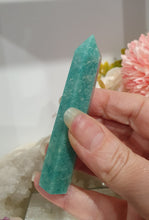 Load image into Gallery viewer, Amazonite Crystal Point Tower Stone.  Shes a tad wobbly.

INSPIRES HOPE

Lovely Amazonite crystal point tower. Discounted as a little bit wobbly but still a lovely tower
