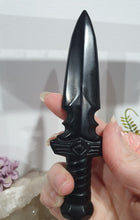 Load image into Gallery viewer, Beautiful polished Black Obsidian Athame (Dagger) Crystal Carving Stone.  

INSPIRES PROTECTION AND BALANCE

An Athame is a ceremonial knife used in spiritual rituals to direct energy, cast circles, and represent the element of fire or air, but it is typically not used for physical cutting.

Stunning polished Black Obsidain Athame Dagger Crystal Carving.


