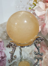 Load image into Gallery viewer, Honey Calcite Sphere Crystal Carving on silver stand

INSPIRES SELF WORTH AND CONFIDENCE

lovely Honey Calcite sphere on ornate silver stand
