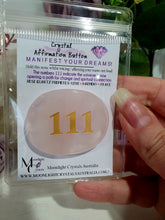 Load image into Gallery viewer, manifest your dreams and desires. Crystal rose quartz Crystal Carving affirmation button. Hold and voice what you desire. 111 indicates the universe to opening up a path for change and reaching your dreams. 
