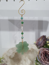 Load image into Gallery viewer, "FOUR-LEAF CLOVER BLESSINGS" Aventurine Crystal Carving Gold Stone Crystal Energy Enhancer© / Hanger / Ornament / Suncatcher

GOOD FORTUNE | HOPE | MAGIC | PROTECTION

A four-leaf clover Symbolises good luck and abundance. It is believed if you hold a four-leaf clover you will gain the ability to see fairies and leprechauns and find their treasures.&nbsp;

Beautiful Aventurine four-leaf clover crystal carving beaded with Amazonite, Aventurine and Quartz. Wire wrapped in Gold

