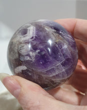 Load image into Gallery viewer, Amethyst Chevron Sphere Crystal Carving Stone on Gold Stand

Inspires INTUITION AND SPIRITUALITY

Lovely Amethyst Crystal Sphere on gold stand.  Gorgeous colouring.  
