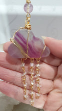 Load image into Gallery viewer, Lovely "EVERY CLOUD HAS A SILVER LINING" Fluorite Cloud gold wired Crystal Energy Enhancer© Hanger Ornament Suncatcher.

From Darkness comes Light. 

TRANSFORMATION / INTUITION / SPIRITUALITY

Beautiful Fluorite Cloud Crystal Carving beaded with Fluorite &amp; Quartz.  wired in Gold

