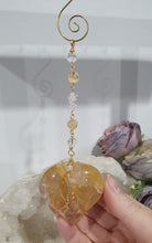 Load image into Gallery viewer, This stunning Ultimate Healer Crystal Energy Enhancer Suncatcher is handcrafted and created with a stunning Golden Healer heart and beaded with golden healer and quartz. Hang in your home or space and feel the ambient energy. Inspires Power and connection. See our other Crystal Suncatchers
