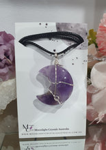 Load image into Gallery viewer, Amethyst Moon Crystal Pendant Wire Wrapped Silver Stone with black cord chain

INSPIRES INTUITION AND SPIRITUALITY

Beautiful Amethyst Moon Crystal Carving Wire Wrapper in Silver non tarnish wire. Accompanied by a black cord necklace

