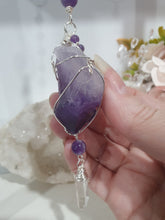 Load image into Gallery viewer, "THE MYSTIC AWAKENING" Handcrafted Amethyst Raw Crystal Stone Silver Crystal Energy Enhancer© Hanger Ornament Suncatcher

INSPIRES INTUITION, WISDOM AND SPIRITUALITY

Stunning Raw Amethyst crystal stone beaded with Amethyst and Quartz. Wire wrapped in silver

Genuine Crystals. no plastic or glass. Ensuring energy flow throughout the enhancer. Hang in your home, work, space and even on your Christmas tree!.  
Genuine Crystal Suncatchers Hangers Christmas Tree Ornaments decorations
