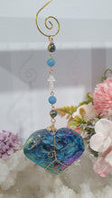 Load image into Gallery viewer, HEART OF THE OCEAN" Handcrafted Titanium Aura Sphalerite Heart Stone Crystal Carving Gold Crystal Energy Enhancer© / Hanger / Ornament / Suncatcher

Inspires PSYCHIC FLOW | LOVE | INTUITION

Gorgeous Titanium Aura Sphalerite heart crystal carving beaded with Aquamarine, Rainbow Hematite &amp; Quartz.  Wire wrapped in gold
