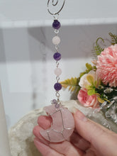 Load image into Gallery viewer, THE PINK MOON" Handcrafted Rose Quartz Moon Carving Stone Silver Crystal Energy Enhancer© Hanger Ornament Suncatcher 

INSPIRES LOVE | HARMONY | GROWTH

Beautiful Rose Quartz Moon Crystal Carving beaded with Rose Quartz and Amethyst. wired in silver
