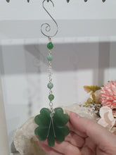 Load image into Gallery viewer, LUCKY FOUR-LEAF CLOVER BLESSINGS" Handcrafted Aventurine Crystal Carving Silver Stone Crystal Energy Enhancer© / Hanger / Ornament / Suncatcher 

Promotes GOOD FORTUNE | HOPE | MAGIC | PROTECTION

A four-leaf clover Symbolises good luck and abundance. It is believed if you hold a four-leaf clover you will gain the ability to see fairies and leprechauns and find their treasures. 

Beautiful Aventurine four-leaf clover crystal carving beaded with Amazonite, Aventurine and Quartz. Wire wrapped in Silver. 


