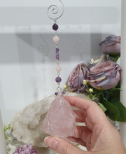 Load image into Gallery viewer, THE LOVE BOMB Rose Quartz Crystal Rough Silver Wired Crystal Energy Enhancer© Hanger Ornament Suncatcher. Inspires Unconditional Love, Harmony, Spirituality. Crystal Suncatchers
