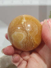Load image into Gallery viewer, Orange Calcite Sphere Crystal Carving Stone on Silver Stand. This has a crack in it

Inspires JOY AND SELF CONFIDENCE

Lovely Orange Calcite Crystal Sphere on silver stand.  Discounted as has a crack. still a gorgeous sphere.  
