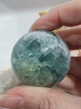 Load image into Gallery viewer, Fluorite Sphere Crystal Carving Stone on Silver Stand

Inspires CONCENTRATION AND STABILITY

Lovely Fluorite Crystal Sphere on silver stand.  super pretty.  Feather fluorite. Amazing pattern.  
